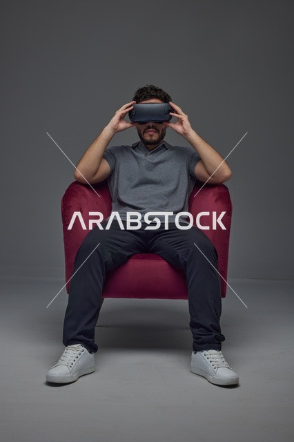 Saudi Man Using VR Headset in Red Armchair