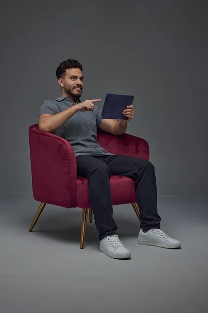 Arab Man Using Tablet Sitting in Armchair