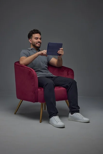 Saudi Man Sitting in Studio Using a Digital Tablet