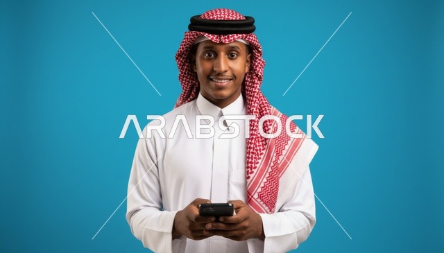Saudi Man Using Smartphone on Blue Background
