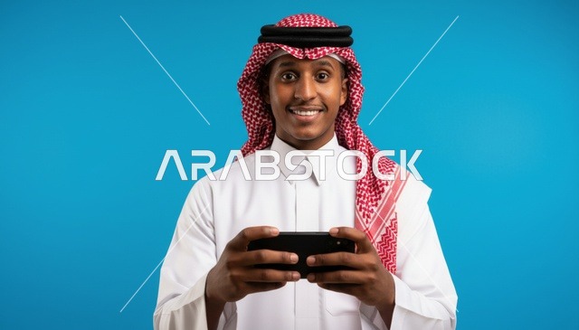 Saudi Man Using Smartphone on Blue Background
