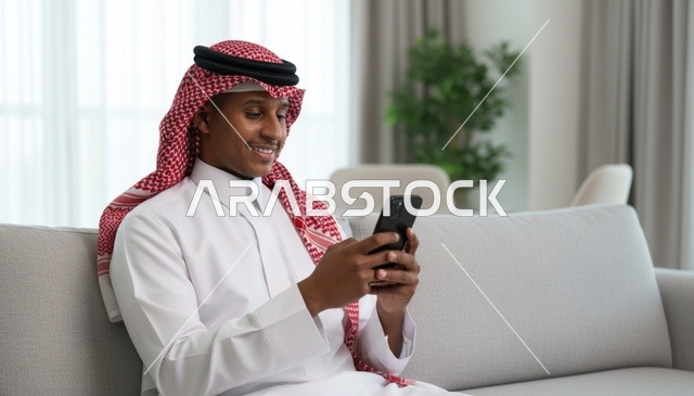 Saudi Man Using Smartphone in Modern Living Room