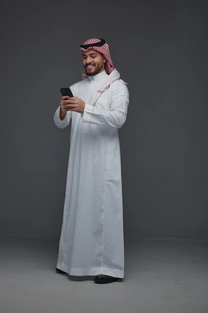 Saudi Man Using Smartphone in Traditional Thobe