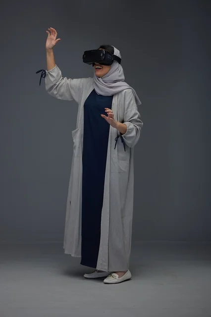 Saudi Woman Using VR Headset on Grey Background