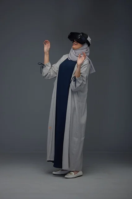 Saudi Woman Using VR Headset in Studio Grey Background