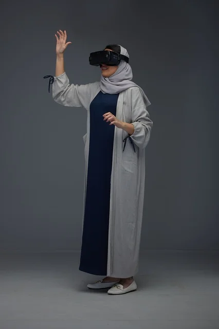 Saudi Woman Wearing VR Headset against Grey Background