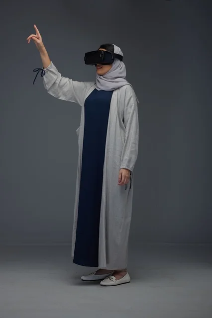 Saudi Woman Using VR Headset and Pointing in Studio