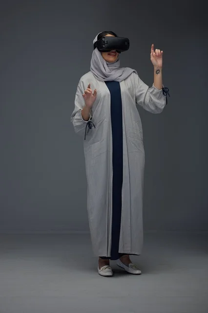 Saudi Woman Wearing Abaya Using VR Headset in Studio