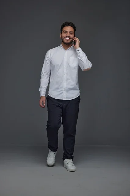 Saudi Man Talking on Smartphone Walking in Studio