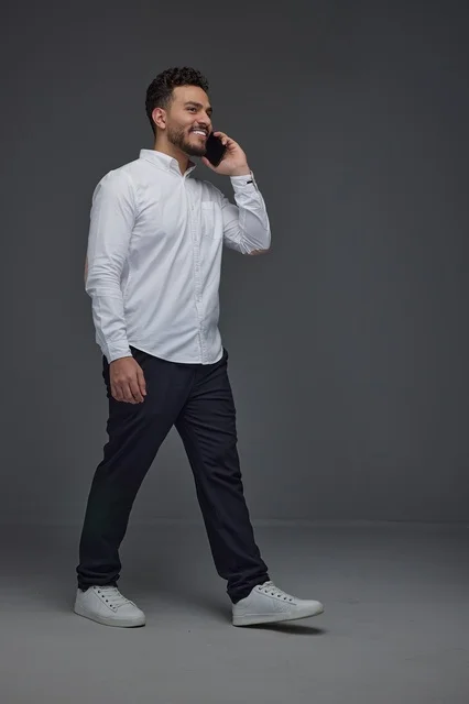 Saudi Man Walking and Talking on Smartphone in Studio