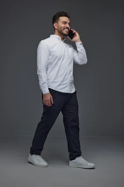 Saudi Man Walking and Talking on Smartphone in Studio