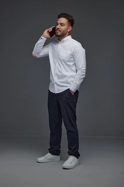 Saudi Man Talking on Smartphone in Studio Full Length