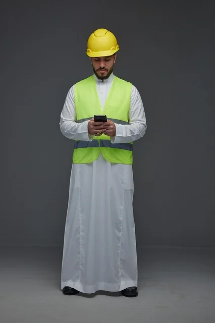 Saudi Engineer with Smartphone in Safety Gear