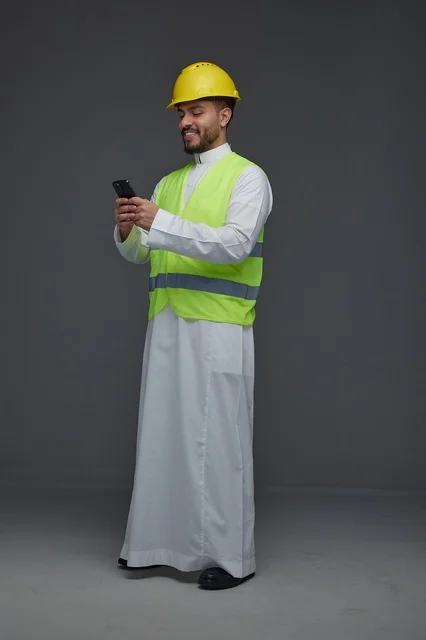 Saudi Engineer in Safety Gear Using Smartphone Studio