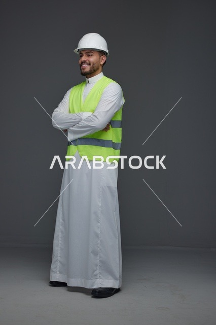 Saudi Engineer in White Hard Hat and Safety Vest Standing