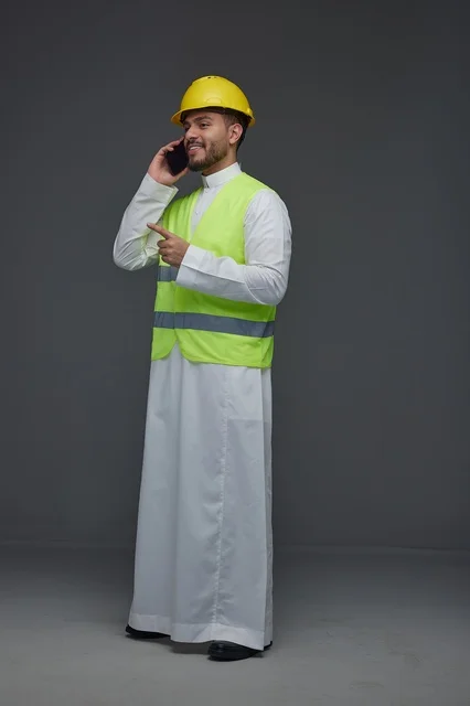 Saudi Engineer in Safety Vest Talking on Mobile Phone