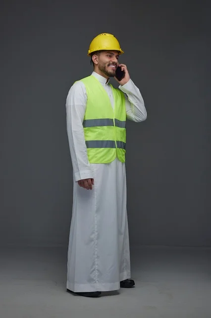 Saudi Engineer in Safety Vest and Hard Hat on Phone