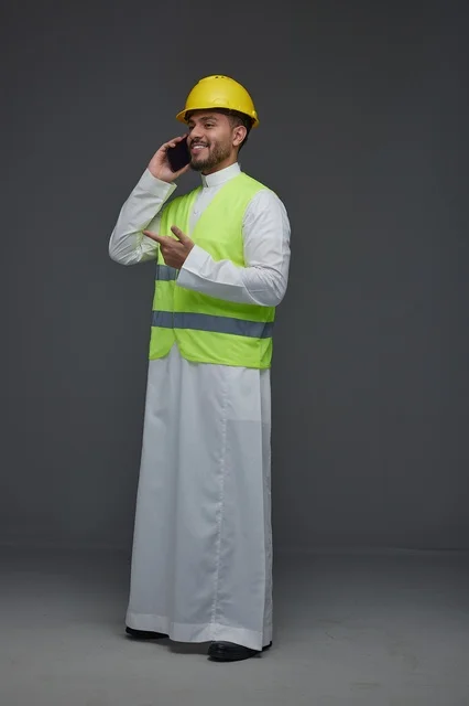 Saudi Engineer in Safety Vest Talking on Mobile Phone