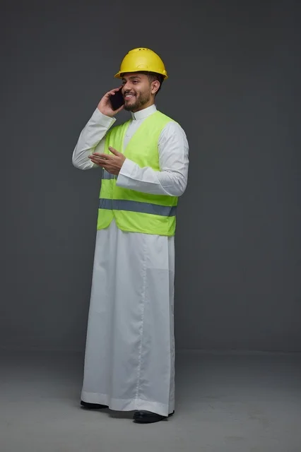 Saudi Engineer in Safety Vest Talking on Smartphone