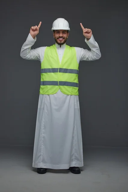 Saudi Engineer Wearing Safety Vest Pointing Upwards
