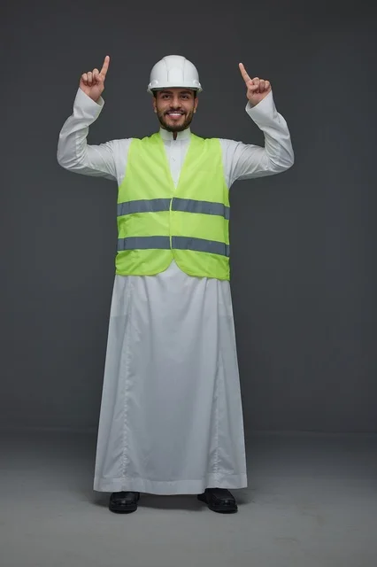 Saudi Engineer in Safety Vest Pointing Upwards in Studio