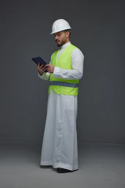 Saudi Engineer in Safety Gear Using Digital Tablet