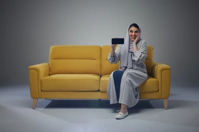 Saudi Woman Sitting on Sofa and interacting with the camera
