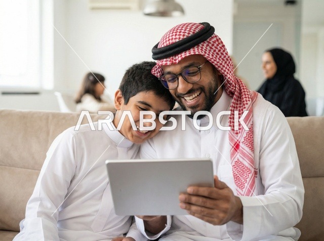 Saudi Father and Son Using Digital Tablet at Home