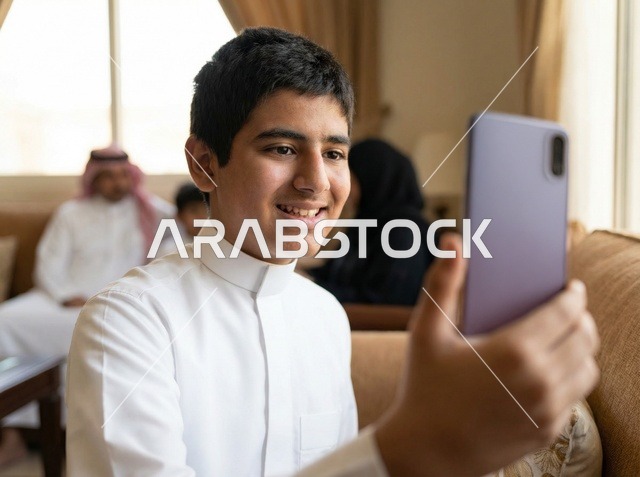 Saudi Boy in White Thobe Taking Smartphone Selfie