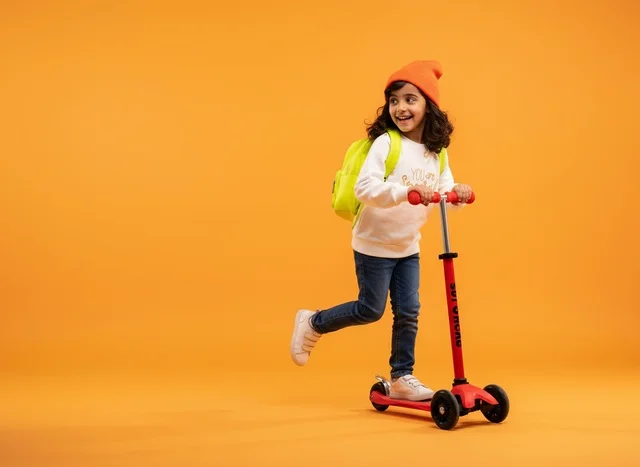 Saudi Girl Riding Red Scooter on Orange Background