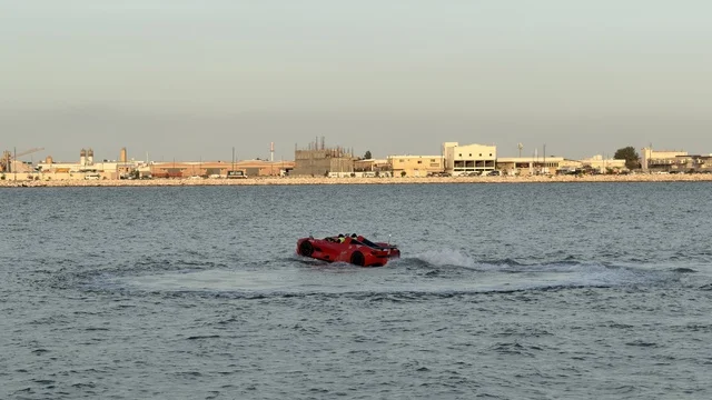 Red Jet Car Maneuvering at Qatif Seafront Saudi Arabia