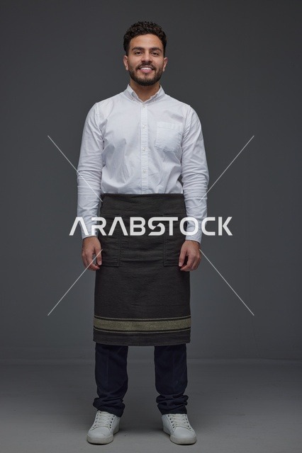 Middle Eastern Waiter in Uniform on Grey Background