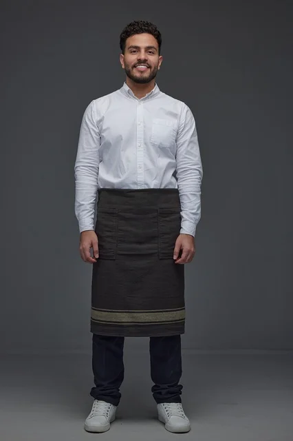 Middle Eastern Waiter in Uniform on Grey Background