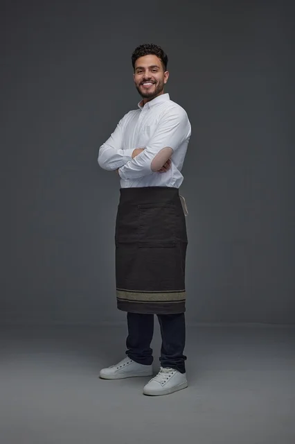 Smiling Saudi Male Worker in Professional Apron Portrait