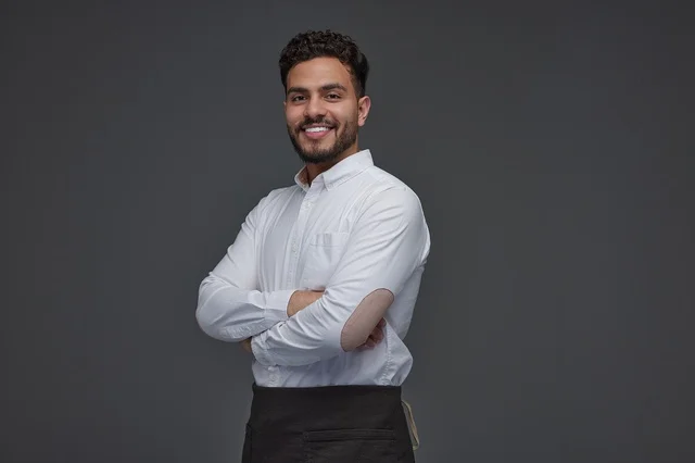 Smiling Saudi Man in Apron Studio Portrait