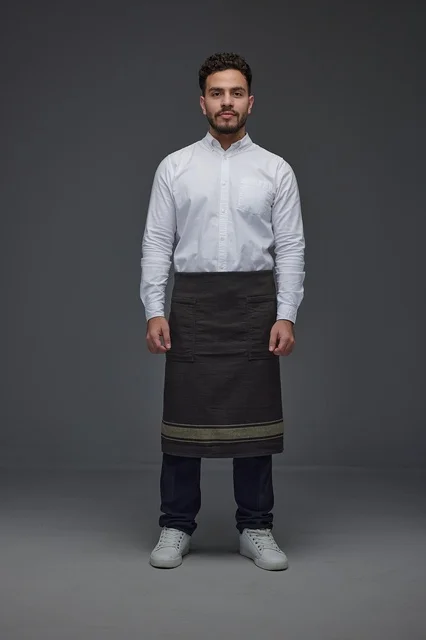 Saudi Man in Waiter Apron Standing in Studio Backdrop