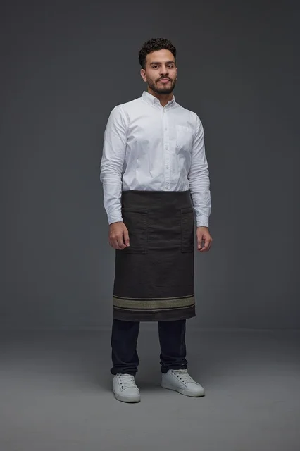 Saudi Waiter in Uniform Standing on Gray Background