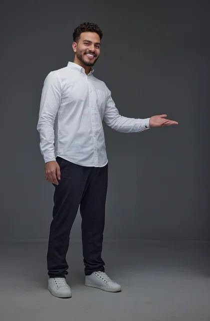 Smiling Saudi Man Gesturing Side Against Grey Background