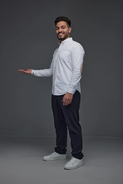 Smiling Saudi Man in White Shirt Gesturing in Studio