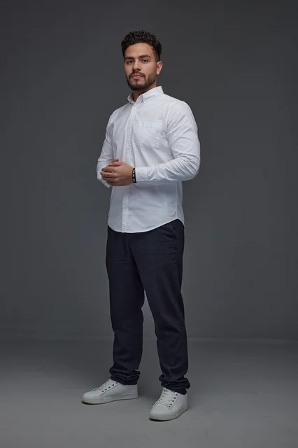 Saudi Man in Modern Casual Attire on Gray Background