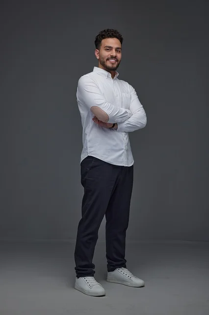 Smiling Saudi Man in Casual White Shirt Studio Portrait