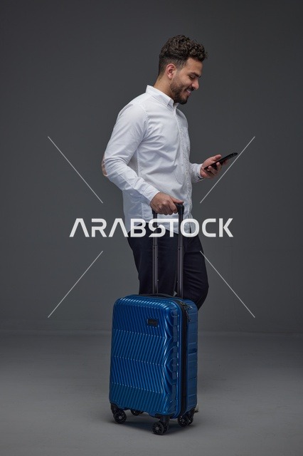 Middle Eastern Man with Suitcase and Smartphone