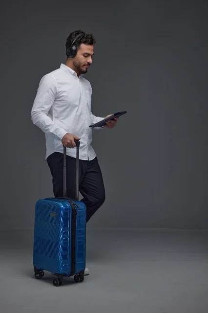 Saudi Traveler with Tablet and Suitcase in Studio