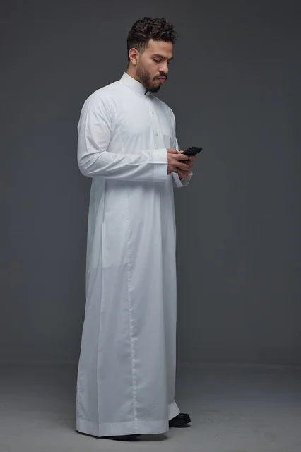 Saudi Man Using Smartphone in Traditional Thobe