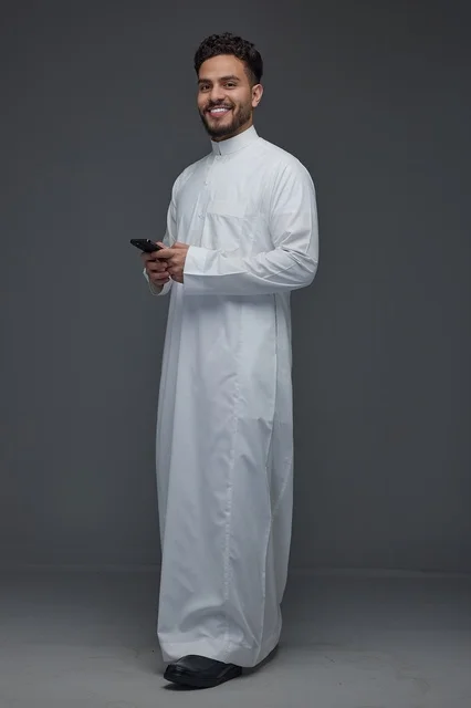 Saudi Man in Traditional Thobe Holding Smartphone