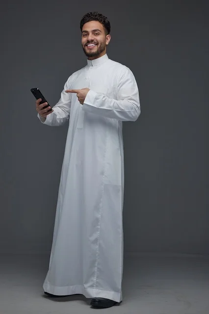 Saudi Man in Thobe Pointing at Smartphone
