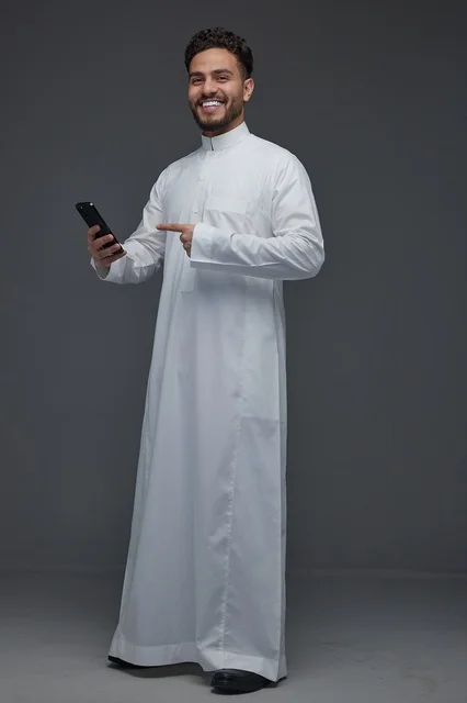 Saudi Man Pointing at Smartphone in Traditional Thobe