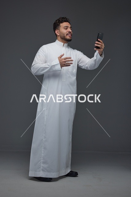 Saudi Man Taking a Selfie in Traditional Thobe