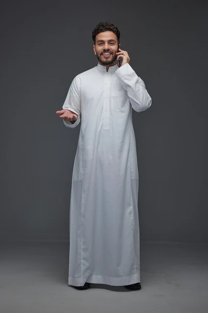 Saudi Man Having a Phone Conversation in Traditional Thobe