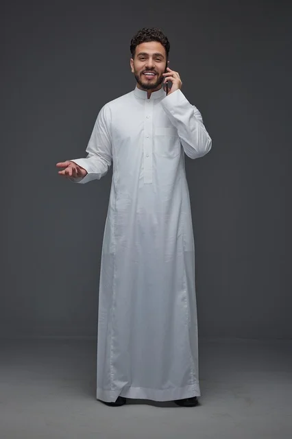 Saudi Man in Traditional Thobe Making a Phone Call